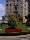 Estatua de Concepción Arenal en el centro de la plaza con jardines florales