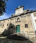Entrada principal de la iglesia con escalinata y puerta verde
