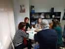 Reunión de miembros de la AECC Ourense en una oficina.