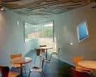 Interior de una sala del Centro Sociocultural de A Trisca con mesas y sillas