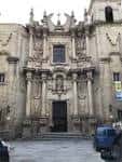 Fachada de la Iglesia de Santa Eufemia a nivel de calle con un vehículo cercano