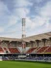 Interior del Estadio Municipal de Pasarón con gradas y torre de iluminación