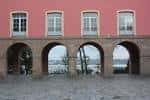 Arcos de la fachada del edificio de la Maestranza con vistas parciales al mar