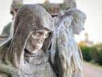 Primer plano de la escultura de la figura encapuchada en el cementerio