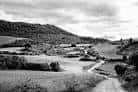 Paisaje rural en blanco y negro con campos y caminos en la región de Ourense