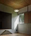 Sala interior con techo de madera, gran ventanal y luz natural