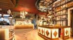 Amplio salón principal con barra de bar y estanterías iluminadas