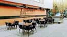 Terraza exterior del Creedence Rock Bar con mesas y sillas