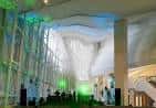 Interior del Museo Centro Gaiás con iluminación ambiental verde y arquitectura moderna