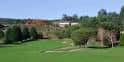 Hoyo del campo de golf con edificios del club en la parte trasera
