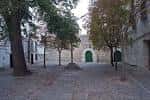 Vista general de la Praza das Bárbaras con árboles verdes y la entrada al convento