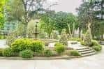 Área de la fuente del parque con abundante vegetación y escalinatas