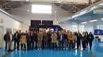 Grupo de asistentes en un evento o visita dentro de una nave industrial moderna