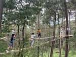 Personas participando en un circuito de aventura entre los árboles del Parque Forestal de Beade