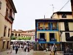 Esquina de calle en Oviedo con edificios tradicionales de colores y actividad peatonal