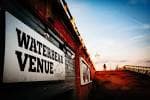 Cartel exterior del WaterBear Venue al atardecer