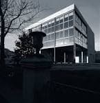 Fachada del Centro de Estudios Avanzados en blanco y negro con detalle de urna en primer plano