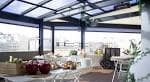 Terraza acristalada tipo sky bar con mobiliario para eventos