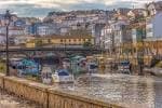 Río Mandeo con embarcaciones y la arquitectura de Betanzos al fondo.