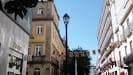 Perspectiva de la Rúa da Raíña con edificios y farola bajo cielo azul