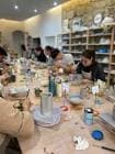 Interior del estudio de cerámica Lamaelume con personas participando en un taller