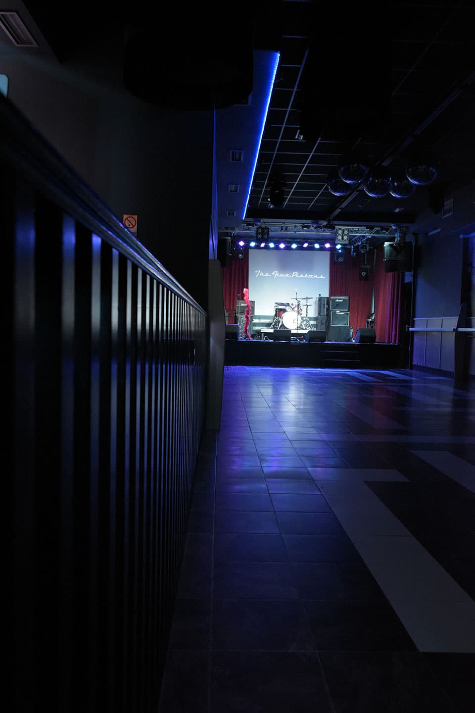 Interior de la Sala Masterclub con escenario iluminado y pista vacía
