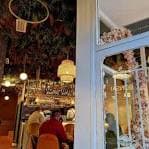 Vista interior del café con barra y decoración floral