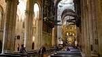 Interior de la nave de la Catedral de Santiago de Compostela con arcos y bancos