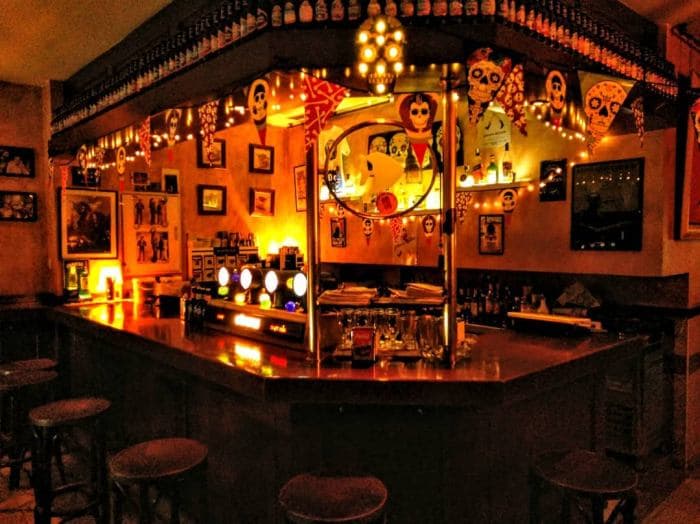 Interior de La Pecera con barra iluminada y ambiente nocturno